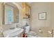 Cozy powder room features a pedestal sink, decorative mirror and medicine cabinet with a stylish ambiance at 733 Hadrian Dr, Garner, NC 27529