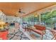 Bright sunroom features tile floors, a wood ceiling, and views of the backyard at 733 Hadrian Dr, Garner, NC 27529