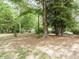 Large backyard surrounded by mature trees and storage shed with plenty of open space for outdoor activities at 81 Sallie Dr, Smithfield, NC 27577