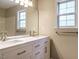 Bathroom featuring a double vanity with marble countertop, modern fixtures, and a large mirror at 81 Sallie Dr, Smithfield, NC 27577