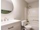 Stylish bathroom with a modern vanity, round mirror, and a shower/tub combo at 81 Sallie Dr, Smithfield, NC 27577