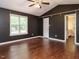 The bedroom includes wood floors, a ceiling fan, and access to an en-suite bathroom for convenience at 81 Sallie Dr, Smithfield, NC 27577