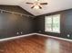 The primary bedroom features wood floors, a ceiling fan, and a large window for natural light at 81 Sallie Dr, Smithfield, NC 27577