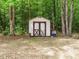 Outdoor shed with red trim and double doors, providing storage and potential for a workshop or hobby space at 81 Sallie Dr, Smithfield, NC 27577