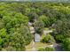 Aerial view of a home nestled amongst lush trees in a quiet neighborhood at 820 Nuttree Pl, Raleigh, NC 27606