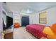 Bright bedroom featuring a red patterned comforter, wood laminate flooring, and a comfy chair at 820 Nuttree Pl, Raleigh, NC 27606