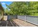 Spacious wood deck with gray lattice railing and lush greenery, ideal for outdoor enjoyment at 820 Nuttree Pl, Raleigh, NC 27606