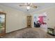 View of the dining room with ceiling fan and living room beyond at 820 Nuttree Pl, Raleigh, NC 27606