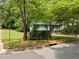 Two story home featuring light blue siding, brick accents, dark trim and a well manicured lawn at 820 Nuttree Pl, Raleigh, NC 27606