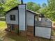 Two story home featuring light blue siding, brick accents, dark trim and lush landscaping at 820 Nuttree Pl, Raleigh, NC 27606
