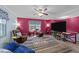Cozy living room featuring plush seating, ceiling fan, and a large television at 820 Nuttree Pl, Raleigh, NC 27606
