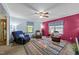 Living room with a ceiling fan, area rug, and plenty of natural light at 820 Nuttree Pl, Raleigh, NC 27606