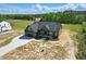 Aerial view of a modern home with a spacious yard and private driveway in a serene, tree-lined neighborhood at 8629 Dukes Lake Rd, Zebulon, NC 27597