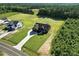 Overhead view of a modern home with well-manicured lawn and a long driveway at 8629 Dukes Lake Rd, Zebulon, NC 27597