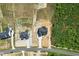 An aerial shot showcases the home's location in relation to a wooded area, road, and surrounding landscape at 8629 Dukes Lake Rd, Zebulon, NC 27597