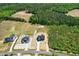An aerial shot showcases the home's location in relation to a wooded area and the main road at 8629 Dukes Lake Rd, Zebulon, NC 27597