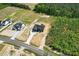 An aerial view of a new home shows the location next to wooded space and road access at 8629 Dukes Lake Rd, Zebulon, NC 27597