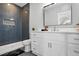 Contemporary bathroom with a stylish vanity, modern fixtures, and a tiled walk-in shower at 8629 Dukes Lake Rd, Zebulon, NC 27597