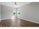 Spacious bedroom featuring wood-look flooring, a ceiling fan, and an abundance of natural light at 8629 Dukes Lake Rd, Zebulon, NC 27597