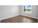 Bright bedroom features a modern ceiling fan, wood-look floors and a sun-filled window at 8629 Dukes Lake Rd, Zebulon, NC 27597