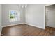 Bright dining room with sleek hardwood floors, modern lighting, and a view to the outdoors at 8629 Dukes Lake Rd, Zebulon, NC 27597