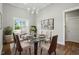 Elegant dining room with a glass table, stylish chairs, and natural light, perfect for entertaining at 8629 Dukes Lake Rd, Zebulon, NC 27597