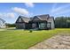 Craftsman style house with black trim, manicured lawns and landscaping around the house at 8629 Dukes Lake Rd, Zebulon, NC 27597