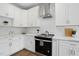 Bright kitchen features white cabinetry, stainless steel appliances, and marble countertops at 8629 Dukes Lake Rd, Zebulon, NC 27597