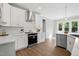 Bright kitchen features white cabinetry, stainless steel appliances, and hardwood floors at 8629 Dukes Lake Rd, Zebulon, NC 27597