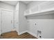 Functional laundry room with built-in shelving and easy access to hookups for appliances at 8629 Dukes Lake Rd, Zebulon, NC 27597