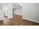 Open living area with hardwood floors, contemporary lighting, and easy access to other rooms at 8629 Dukes Lake Rd, Zebulon, NC 27597