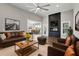 Inviting living room featuring a fireplace, comfortable seating, and an open view into the dining area at 8629 Dukes Lake Rd, Zebulon, NC 27597