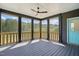Relaxing screened porch with a ceiling fan and wooded backyard views at 8629 Dukes Lake Rd, Zebulon, NC 27597