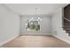 Dining area showcases hardwood floors, large windows, and stylish chandelier lighting at 9305 Field Maple Ct, Raleigh, NC 27613
