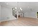 Spacious open-concept area with hardwood flooring seamlessly connects the living, dining, and kitchen spaces at 9305 Field Maple Ct, Raleigh, NC 27613