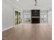 Expansive living room with a modern fireplace, ample natural light, and a sliding glass door to the outdoors at 9305 Field Maple Ct, Raleigh, NC 27613