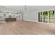 Expansive living room showcasing an open layout, hardwood floors, and large windows for ample natural light at 9305 Field Maple Ct, Raleigh, NC 27613