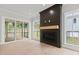 Living room featuring a fireplace with a wooden mantel and a sliding glass door to the screened-in porch at 9305 Field Maple Ct, Raleigh, NC 27613