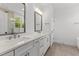 Bathroom features double sink vanity, tile floor, and large mirrors with modern lighting at 9309 Field Maple Ct, Raleigh, NC 27613