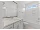 Bright bathroom with a large vanity and white tile bathtub at 9309 Field Maple Ct, Raleigh, NC 27613