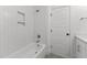 Bathroom featuring tub with modern tile surround and tiled niche for bath supplies at 9309 Field Maple Ct, Raleigh, NC 27613