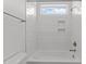 Bright bathroom with a white tile bathtub and a window at 9309 Field Maple Ct, Raleigh, NC 27613
