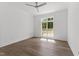 Bedroom with hardwood floors and a large window overlooking the yard at 9309 Field Maple Ct, Raleigh, NC 27613