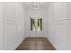 Elegant foyer featuring hardwood floors and white wainscoting, illuminated by modern lighting at 9309 Field Maple Ct, Raleigh, NC 27613