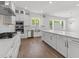 This stunning kitchen features an island, stainless appliances, and marble backsplash at 9309 Field Maple Ct, Raleigh, NC 27613