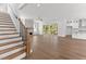 Open-concept living room showcases hardwood floors, fireplace and seamless access to a covered deck at 9309 Field Maple Ct, Raleigh, NC 27613