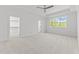 Large bedroom features carpet, ceiling fan, a tray ceiling, and large windows at 9309 Field Maple Ct, Raleigh, NC 27613