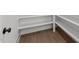 Walk-in pantry boasts built-in shelving and hardwood floors, offering ample storage space at 9309 Field Maple Ct, Raleigh, NC 27613