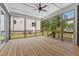 Spacious screened-in back patio with wood floor, ceiling fan, and screened windows at 9309 Field Maple Ct, Raleigh, NC 27613