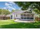 Spacious backyard with a screened-in porch, deck, and lush green lawn at 9404 Dawnshire Rd, Raleigh, NC 27615